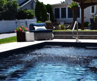 Comfortable backyard with gazebo, loungers and inground pool.