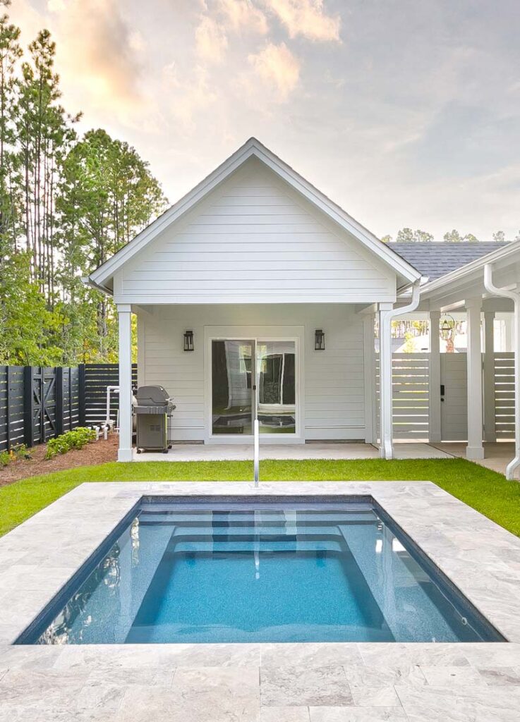 Cozy fenced in backyard with pool house and small plunge pool