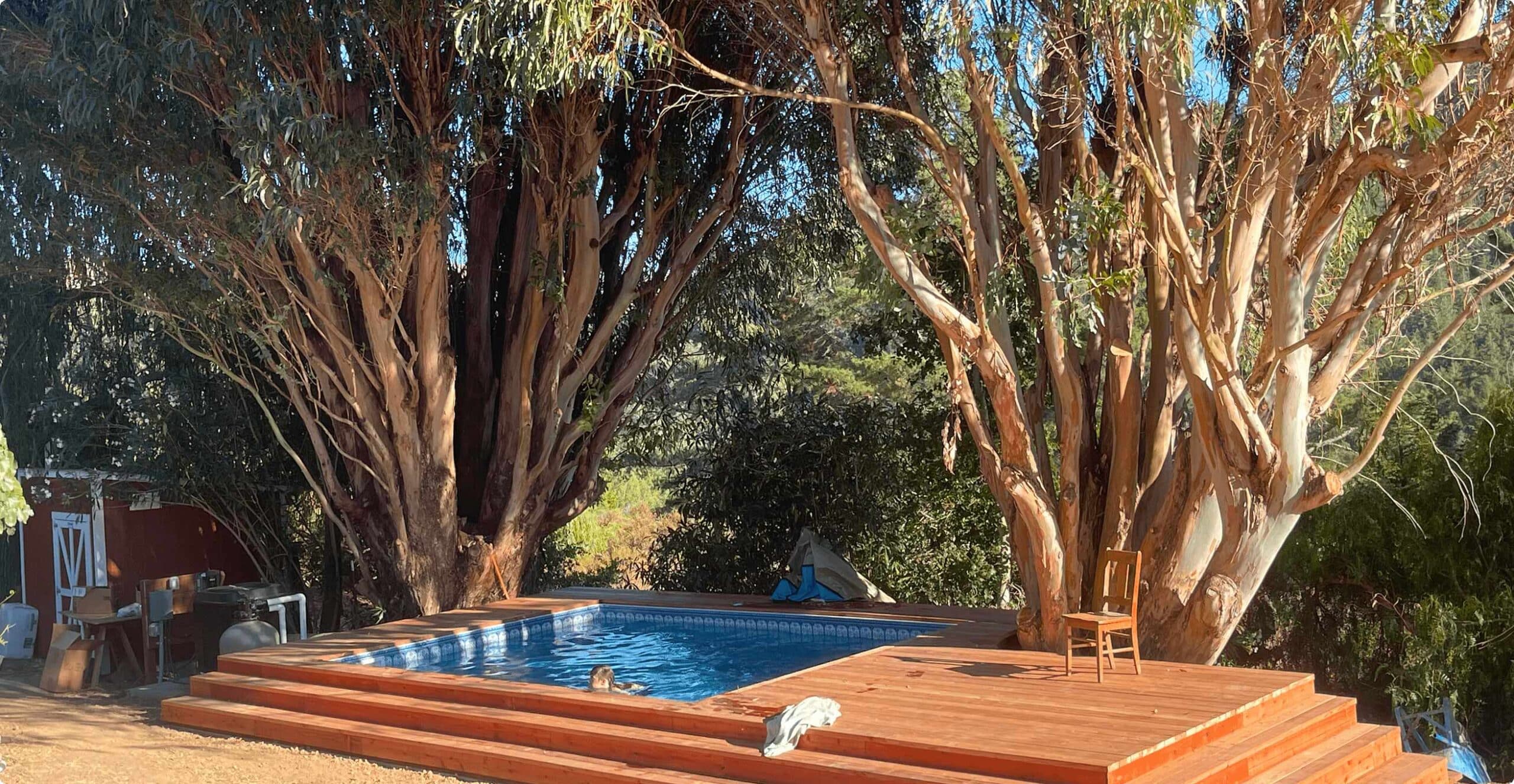 inground pool with wooden decking