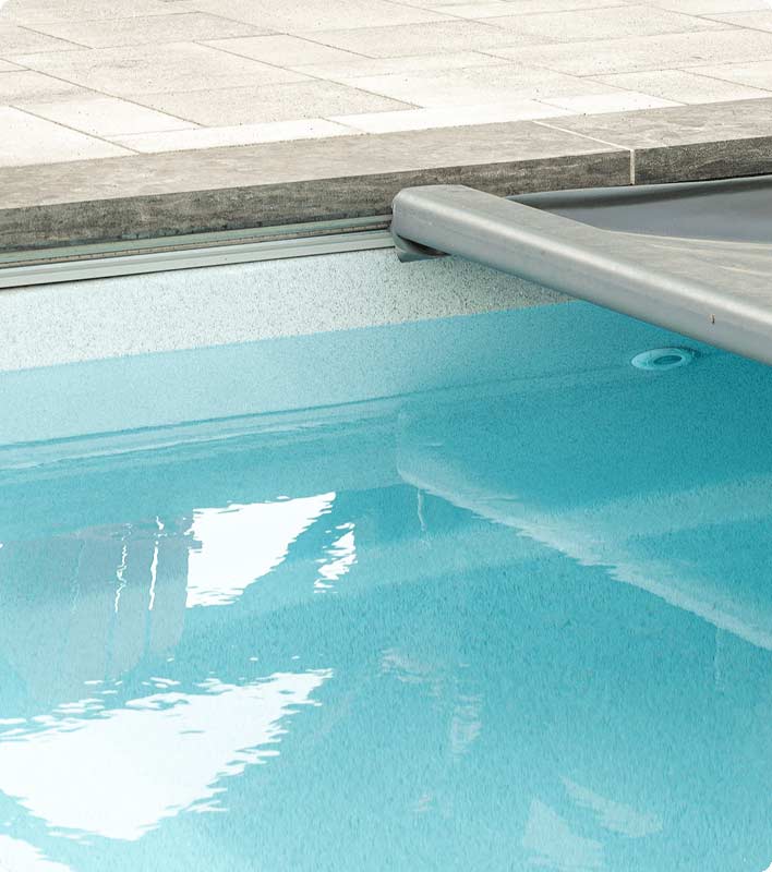 Close up of inground fiberglass pool and safety cover