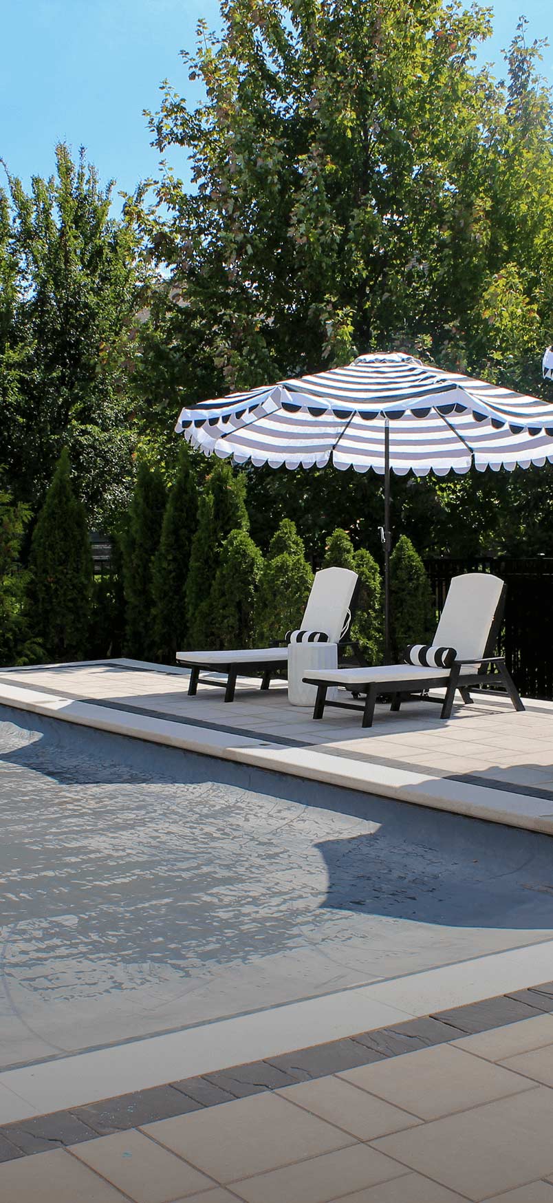 inground pool with grey automatic safety cover closed