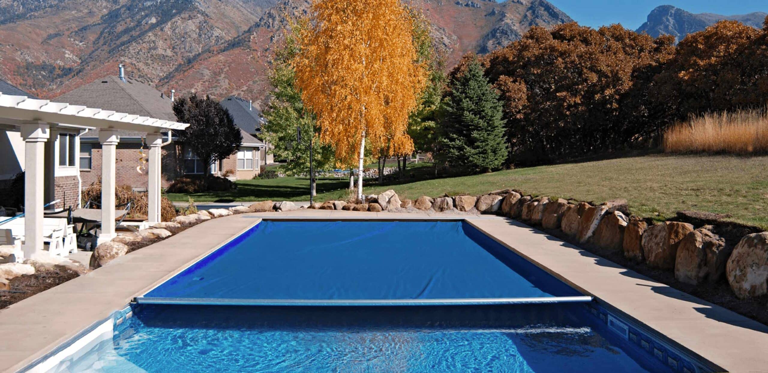 inground pool with blue automatic safety cover