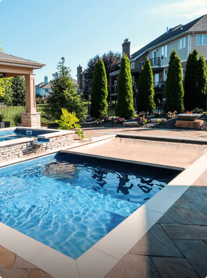 inground swimming pool with tan automatic safety cover
