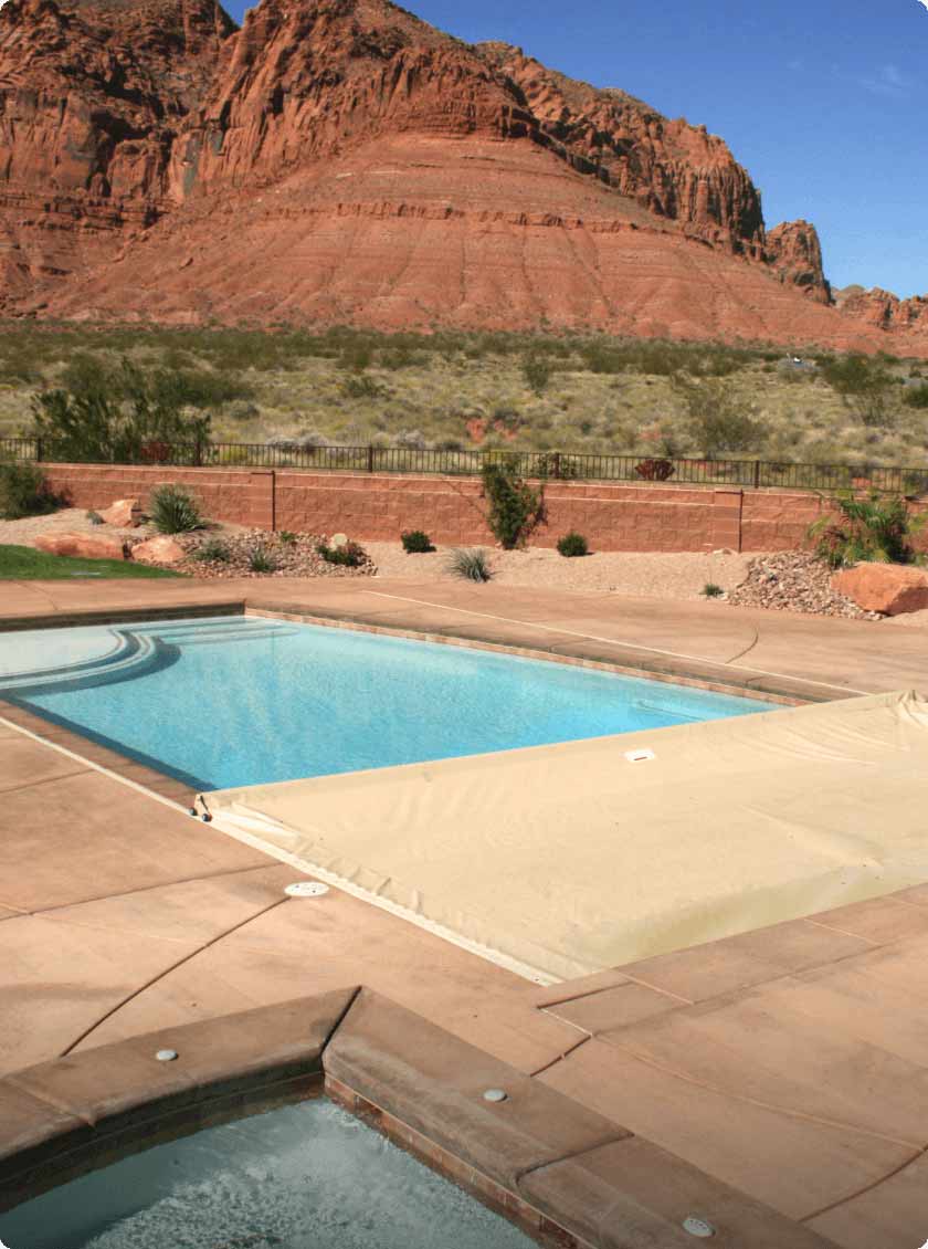 inground pool in dessert backyard with automatic safety cover