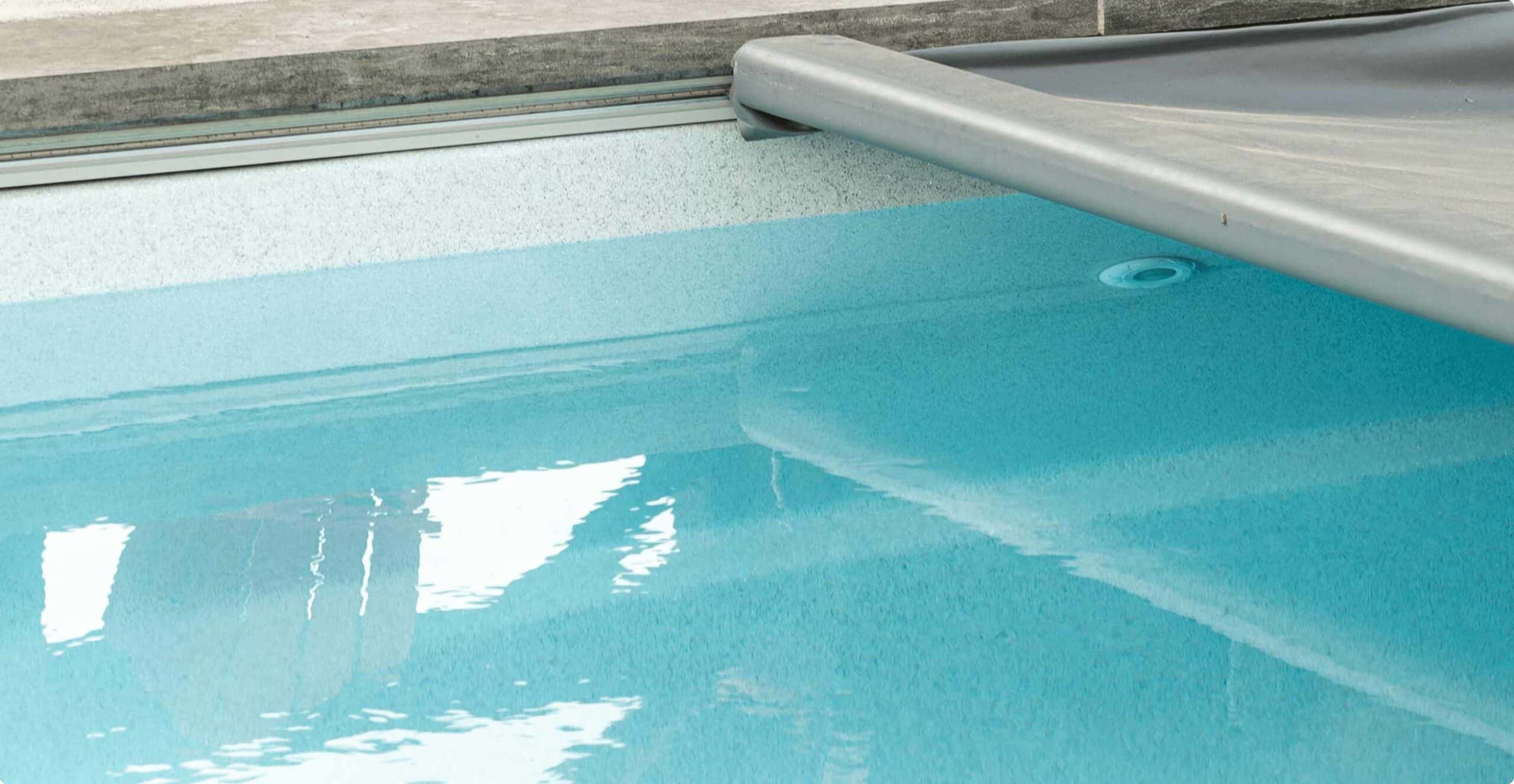 Close up of inground fiberglass pool and safety cover