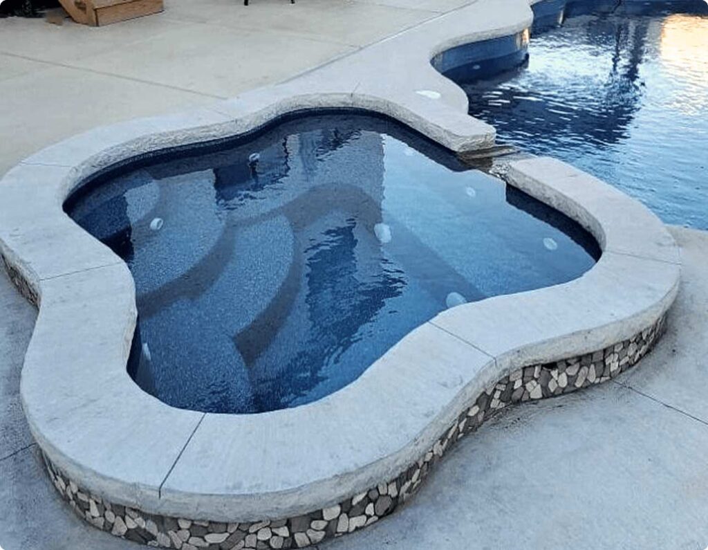 05_t_product-overview_spas_regal-spillover_03freeform-crystite-classic-ocean-blue-fiberglass-spa-concrete-deck.jpg_2x