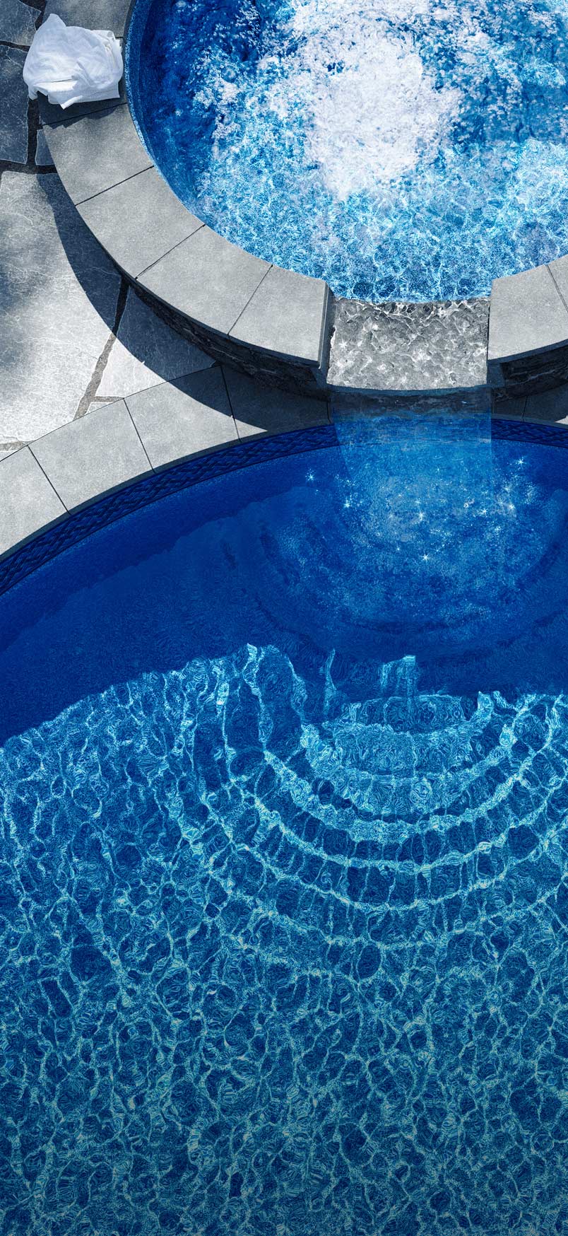 Overview of spa overflowing into inground pool